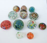 Twelve glass paperweights including Murano and Mdina