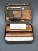 A Lee Enfield .303 unused rifle cleaning kit in original metal tin.