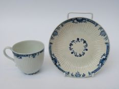 A first period Worcester tea cup and saucer with open crescent mark to base