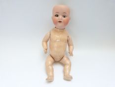 Armand Marseille bisque headed doll with open mouth, weighted brown eyes and jointed composite body,
