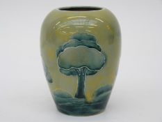 Moorcroft pottery vase decorated in the Hazeldene pattern with green Moorcroft signature to base