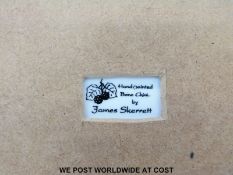 A porcelain plaque hand decorated with a polar bear by James Skerrett,