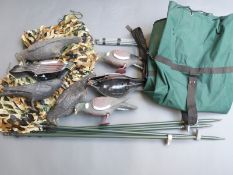 A set of pigeon and crow decoys with poles and net in a canvas carry bag.