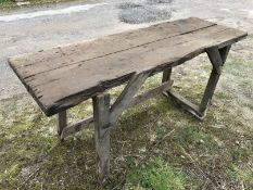 A rustic trestle table or work bench.
