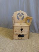 A child's pine commode with pierced fleur cutaway design to back in rustic folk art style (height