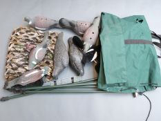 A set of pigeon and crow decoys with poles and net in a canvas carry bag.