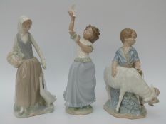 Three Nao figures including a boy with a ram