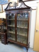 A late 19thC astragal glazed mahogany cabinet with dogs tooth adjustable shelving,