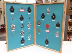 A two-sided fold-out display of Metropolitan and Kent police badges c1930s onwards