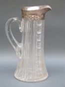 A hallmarked silver and cut glass claret jug by Gorham Manufacturing Co.