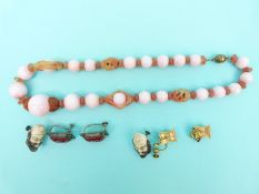 A pair of yellow metal earrings in the form of Ashanti pillows,