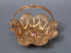 A filigree gilt basket with all over pierced scrolling decoration and an enamel Maltese Cross to