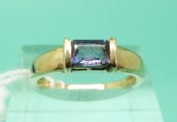 A 9ct gold ring set with an emerald cut amethyst (Size N)