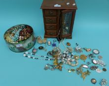 A collection of costume jewellery to include brooches, silver bracelets, beads, earrings, locket,