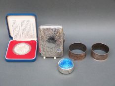 A hallmarked silver cigarette case, guilloche enamel pill box, 1977 coin and pair of napkin rings,