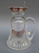 A hallmarked silver and cut glass whisky noggin with matching whisky label,