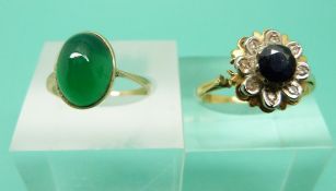 An 18ct gold ring set with a sapphire surrounded by diamonds and a 9ct gold ring set with a green
