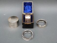 Four various hallmarked silver napkin rings including a cased example,
