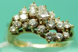 An 18ct gold ring set with 21 round cut diamonds in a floral cluster, total diamond weight approx 0.