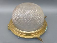 A cut glass brass framed ceiling lamp with hinged porthole style frame,