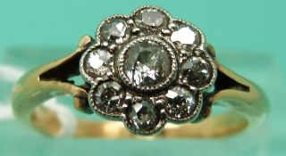 An 18ct gold ring set with old cut diamonds in a cluster setting (Size O)