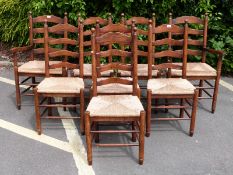 A set of 8 (6+2) oak ladder back rush seated dining chairs