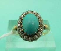 A Victorian 18ct gold ring set with a turquoise cabochon surrounded by old cut diamonds (size O)