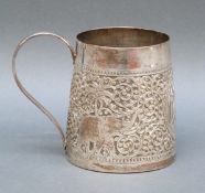 An Indian, Burmese or similar white metal tankard of tapering form with embossed decoration,