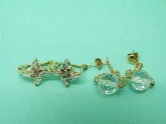 A pair of 14ct gold earrings together with a pair of 9ct gold earrings.