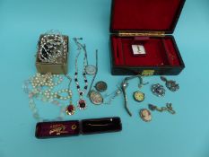 A collection of costume jewellery including three silver lockets,