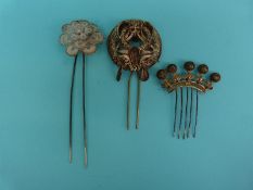 A white metal filigree hair pin in the form of a flower with tiered sections,