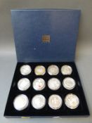 A case containing twelve various commemorative crowns,
