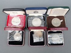 Three cased commemorative crowns together with three cased 50 pence pieces