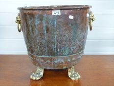 A Georgian riveted copper copper with looped lion mask handles, raised on paw feet, H40.