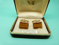 A pair of 9ct gold cufflinks set with tigers eye, 10g.