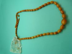 A graduated amber necklace made up of oval egg yolk coloured beads, 31g.