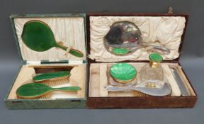 A cased hallmarked silver dressing table set comprising mirror and two brushes together with a
