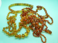 Seven pressed amber necklaces made up of translucent/ transparent beads