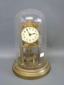 A brass anniversary clock under glass dome, with Arabic dial and movement by Gustav Becker,