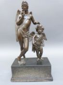 A bronze figural group of a winged god with putti,
