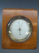 French aneroid barometer in beech case with silvered dial and curved thermometer to lower dial,