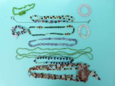 A large quartz pendant on a three strand necklace made up of carnelian agate,