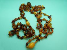 Two amber necklaces made up of irregular opaque butterscotch colour beads and translucent beads
