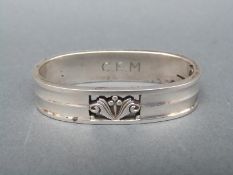 A Georg Jensen white metal oval napkin ring marked sterling and Georg Jensen 173A,