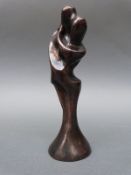 A bronze statue of two people embracing,