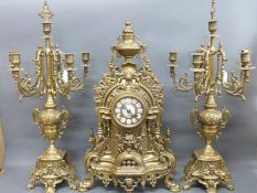A substantial ornate brass garniture clock, enamelled Roman numerals inset to dial, pierced hands,