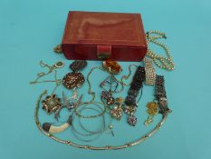 A collection of costume jewellery to include a white metal and ivory brooch,