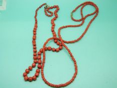 Two strands of coral beads with gold clasps.