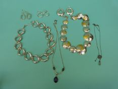 Two large silver necklaces and matching earrings and two smaller silver necklaces one in the Arts &