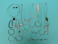 A collection of silver to include bangles, some set with cubic zirconia,